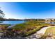 Tranquil lake view, featuring a walkway and marshy landscape at 19375 Water Oak Dr # 203, Port Charlotte, FL 33948