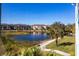 Community lakefront view with lush landscaping and apartment buildings at 19375 Water Oak Dr # 203, Port Charlotte, FL 33948
