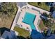 Aerial view of community pool with surrounding lounge chairs at 19375 Water Oak Dr # 203, Port Charlotte, FL 33948