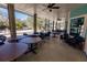Relaxing screened porch with tables and chairs overlooking a lake at 19375 Water Oak Dr # 203, Port Charlotte, FL 33948