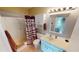 Clean bathroom with shower/tub combo, vanity, and linen storage at 22375 Edgewater Dr # 147, Punta Gorda, FL 33980