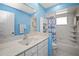 Clean bathroom with white vanity, bathtub, and blue walls at 2275 Kenya Ln, Punta Gorda, FL 33983