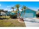 Beautiful teal home with palm trees and a two-car garage at 2275 Kenya Ln, Punta Gorda, FL 33983