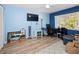 Home office with wood floors, desk, and large window at 2275 Kenya Ln, Punta Gorda, FL 33983