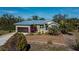 Single-story house with metal roof, attached garage, and landscaped yard at 24362 Yacht Club Blvd, Punta Gorda, FL 33955