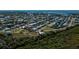 Aerial showing neighborhood with canal-front homes and tropical foliage at 24362 Yacht Club Blvd, Punta Gorda, FL 33955