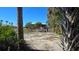 Spacious backyard with a playset and tropical landscaping at 24362 Yacht Club Blvd, Punta Gorda, FL 33955