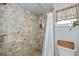 Clean bathroom with a shower/tub combo and updated tile at 24362 Yacht Club Blvd, Punta Gorda, FL 33955