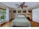 Bright bedroom with hardwood floors, large windows, and ceiling fan at 24362 Yacht Club Blvd, Punta Gorda, FL 33955