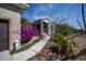 Home's exterior showcasing walkway, vibrant flowers, and landscaping at 24362 Yacht Club Blvd, Punta Gorda, FL 33955