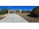 Single-story house with metal roof, attached garage, and landscaped yard at 24362 Yacht Club Blvd, Punta Gorda, FL 33955