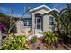 Front entrance with lush landscaping and a welcoming walkway at 24362 Yacht Club Blvd, Punta Gorda, FL 33955