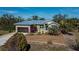 Single-story house with metal roof, attached garage, and landscaped yard at 24362 Yacht Club Blvd, Punta Gorda, FL 33955
