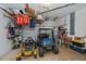 Organized garage with golf cart and lawn equipment at 24362 Yacht Club Blvd, Punta Gorda, FL 33955