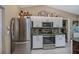 Modern kitchen with stainless steel appliances and wood cabinets at 24362 Yacht Club Blvd, Punta Gorda, FL 33955