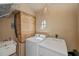 Laundry room with washer, dryer, and built-in storage at 24362 Yacht Club Blvd, Punta Gorda, FL 33955