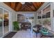 Bright sunroom featuring wicker chairs and access to the backyard at 24362 Yacht Club Blvd, Punta Gorda, FL 33955