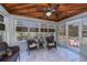 Relaxing sunroom with wicker furniture and wood ceiling at 24362 Yacht Club Blvd, Punta Gorda, FL 33955