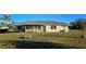 Landscaped backyard with a spacious grassy area at 25075 Palisade Rd, Punta Gorda, FL 33983