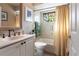 Clean bathroom with a bathtub, stained glass window, and updated vanity at 25188 Marion Ave # 12, Punta Gorda, FL 33950