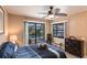 Bedroom with pool view, featuring a comfortable bed and dresser at 25188 Marion Ave # 12, Punta Gorda, FL 33950