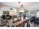 Formal dining room with wood table, chandelier, and views of the living room at 25188 Marion Ave # 12, Punta Gorda, FL 33950