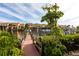 Wooden dock leading to the water with lush foliage at 25188 Marion Ave # 12, Punta Gorda, FL 33950