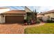 Brick driveway and nicely landscaped front yard with red chair at 25188 Marion Ave # 12, Punta Gorda, FL 33950