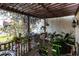 Relaxing covered patio with numerous potted orchids at 25188 Marion Ave # 12, Punta Gorda, FL 33950