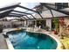 Inviting kidney shaped pool with covered patio and lush landscaping at 25188 Marion Ave # 12, Punta Gorda, FL 33950