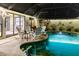 Relaxing pool area with patio furniture and a covered seating area at 25188 Marion Ave # 12, Punta Gorda, FL 33950