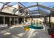 Inviting pool area with covered patio, deck, and lush landscaping at 25188 Marion Ave # 12, Punta Gorda, FL 33950