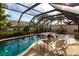 Inviting pool area with a screened enclosure and patio furniture at 25188 Marion Ave # 12, Punta Gorda, FL 33950
