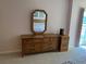 Bedroom showcasing a dresser with mirror and a small cabinet at 25188 Marion Ave # F201, Punta Gorda, FL 33950