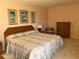 Bedroom with king-size bed and dresser at 25188 Marion Ave # F201, Punta Gorda, FL 33950