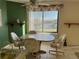 Bright breakfast nook with a cozy table and serene water view, perfect for enjoying meals in natural light at 25188 Marion Ave # F201, Punta Gorda, FL 33950