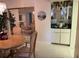 Elegant dining area featuring a classic table setting, mirrored wall and a built-in bar for entertaining guests at 25188 Marion Ave # F201, Punta Gorda, FL 33950