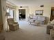 Comfortable living area featuring plush seating, soft carpet and natural light, perfect for relaxing and entertaining at 25188 Marion Ave # F201, Punta Gorda, FL 33950