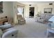 Spacious living room with ample seating and natural light at 25188 Marion Ave # F201, Punta Gorda, FL 33950