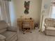 Living area features comfortable seating and a home office at 25188 Marion Ave # F201, Punta Gorda, FL 33950