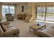 Bright living room with multiple seating areas and large windows at 25188 Marion Ave # F201, Punta Gorda, FL 33950