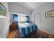 Bright bedroom with blue bedding and wood floors at 25316 Rupert Rd, Punta Gorda, FL 33983