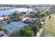 An aerial view of a house with the community pool and tennis courts nearby at 26166 Stillwater Cir, Punta Gorda, FL 33955