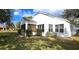 View of the backyard with a screened-in porch and well-maintained landscaping at 26166 Stillwater Cir, Punta Gorda, FL 33955