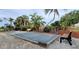 Enjoy outdoor leisure with a beautifully landscaped bocce ball court, surrounded by lush tropical foliage and seating at 26166 Stillwater Cir, Punta Gorda, FL 33955