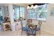 Bright breakfast nook with tile floors, glass table, and views of lush greenery at 26166 Stillwater Cir, Punta Gorda, FL 33955