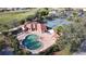 Aerial view of a community pool surrounded by lounge chairs and lush landscaping at 26166 Stillwater Cir, Punta Gorda, FL 33955