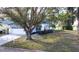 Charming single-story home with a well-manicured lawn and mature trees at 26166 Stillwater Cir, Punta Gorda, FL 33955