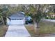Charming single-story home featuring a well-maintained lawn, two-car garage, and mature shade trees at 26166 Stillwater Cir, Punta Gorda, FL 33955