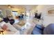 Open-concept living room with tile floors and views of the kitchen and front door at 26166 Stillwater Cir, Punta Gorda, FL 33955